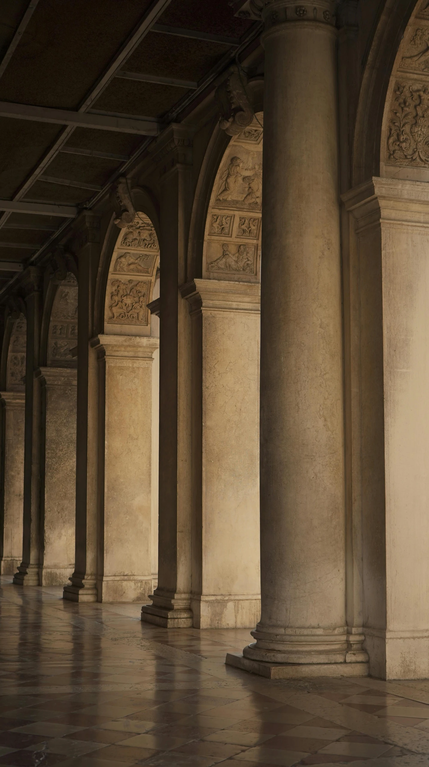 pillars and a clock sit in the middle of a building