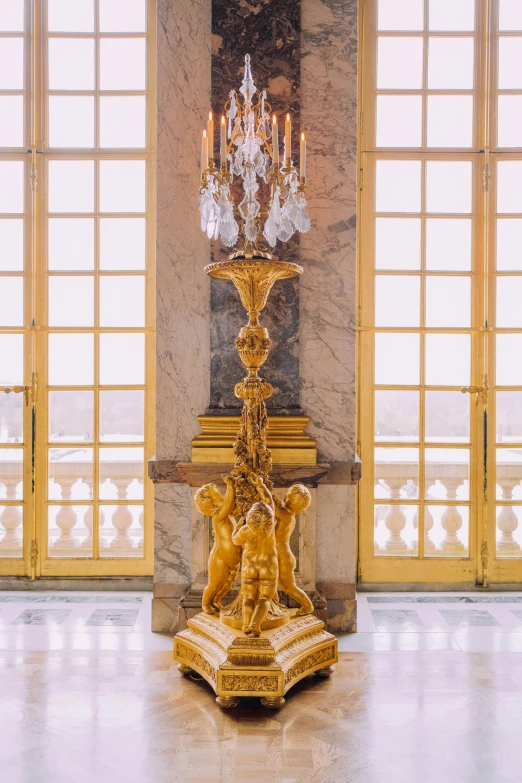 an ornate golden pedestal with candles on top