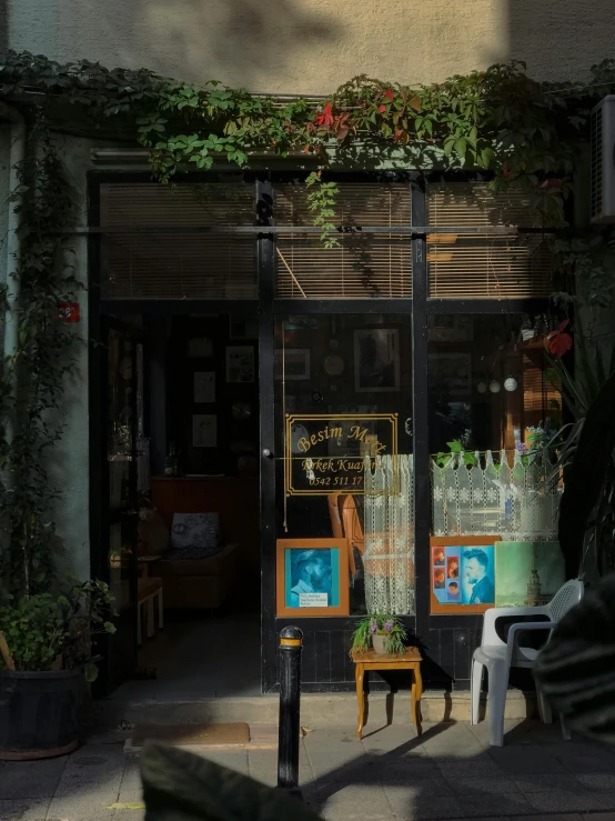 an entrance to a store with a woman's torso visible