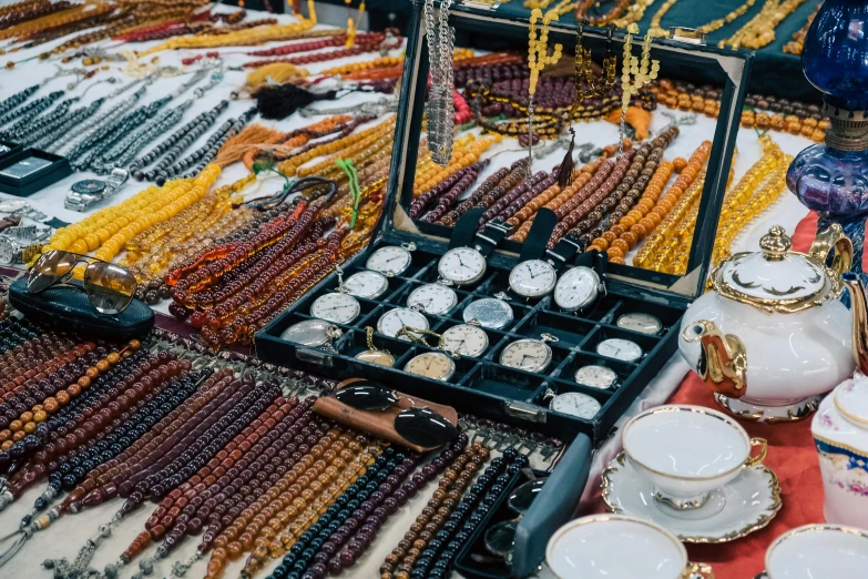 rows of beads and tea pots sit on display