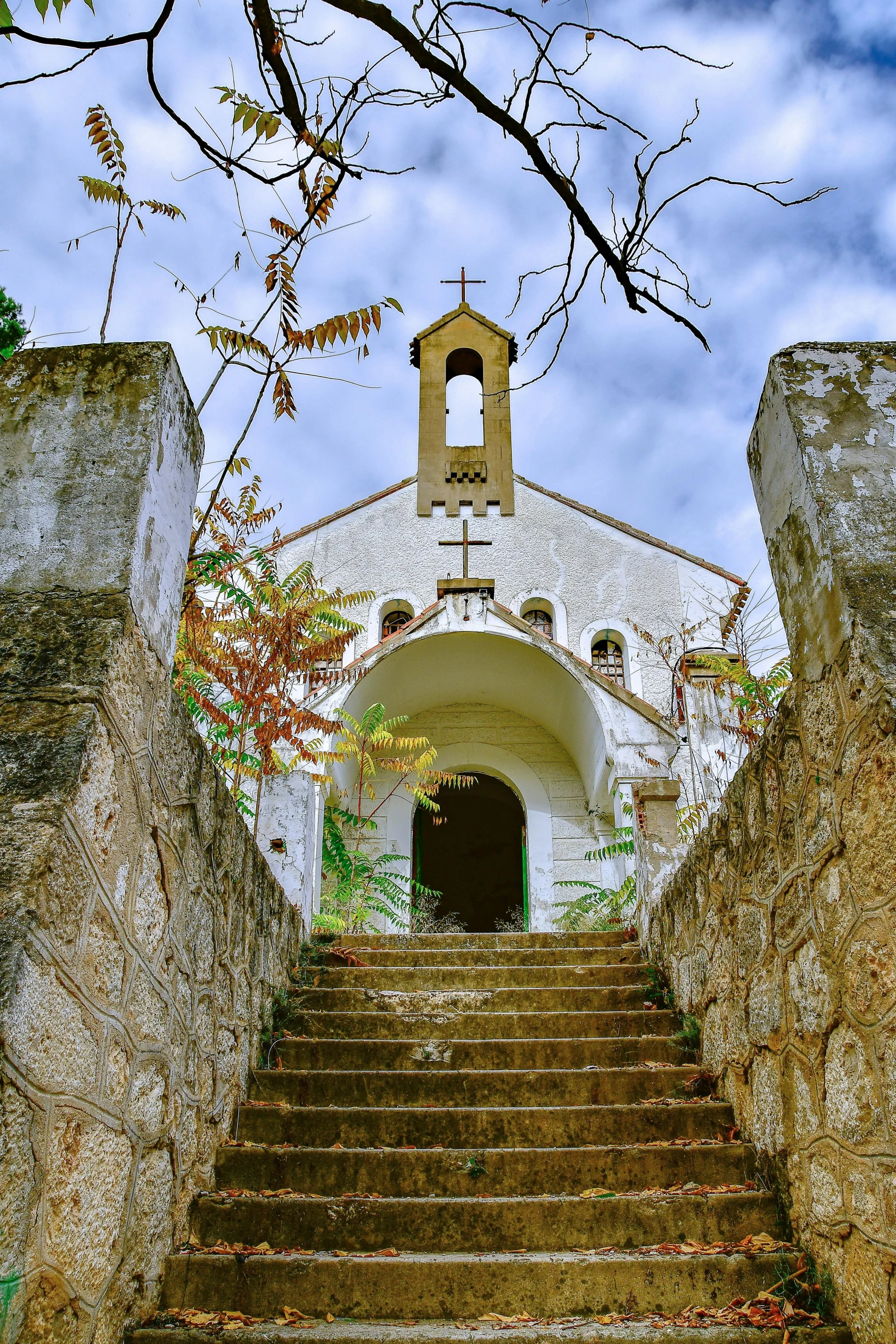 a staircase going up to an old white church