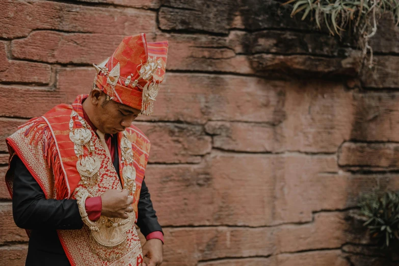 a man dressed in an indian costume looking at his cell phone