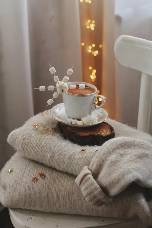 a white chair with a cup and saucer on it