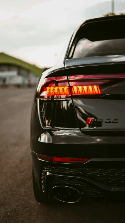 the tail lights on a black car are shown