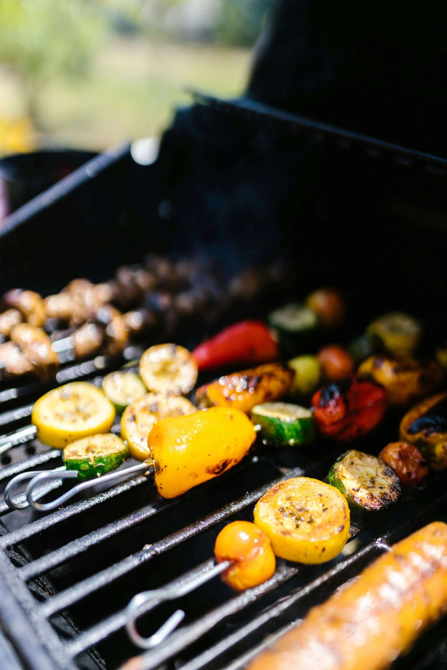 assorted vegetables cooking on the grill outside