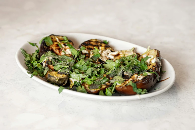 this is an oval dish containing green and red vegetables