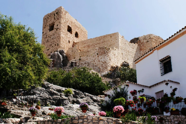 a large stone castle style building with a garden area