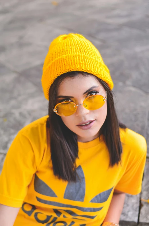  wearing a yellow cap and sunglasses