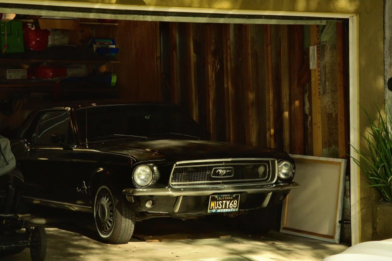 a black car parked next to a storage shed