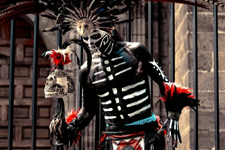 a man dressed as a skeleton standing next to a gate