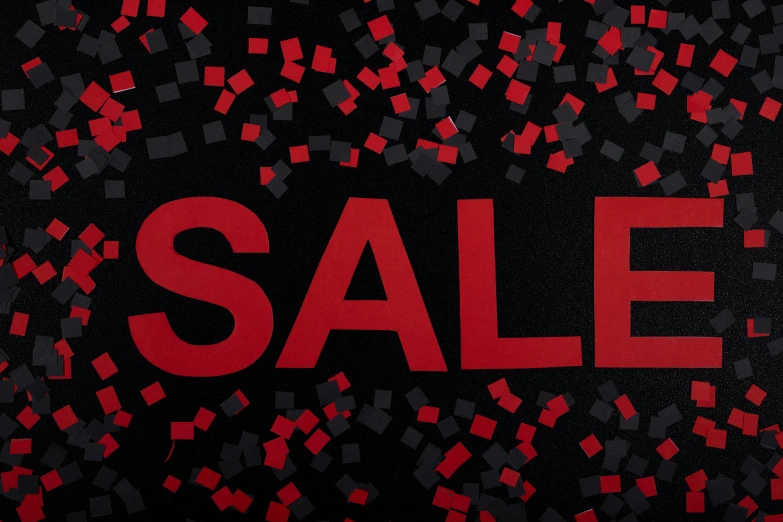 a red sale sign on the side of a dark background