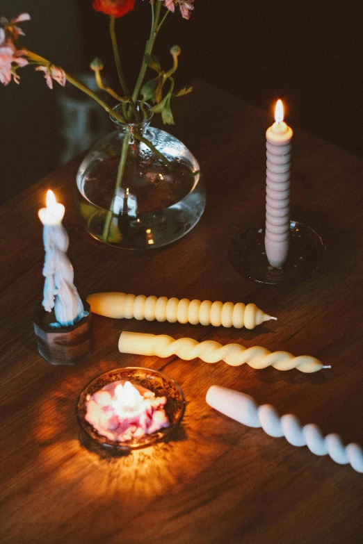 the candles are lit and in vase with flowers