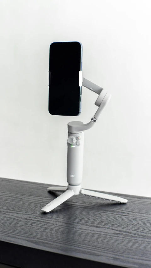a phone sitting on the top of a white and black holder