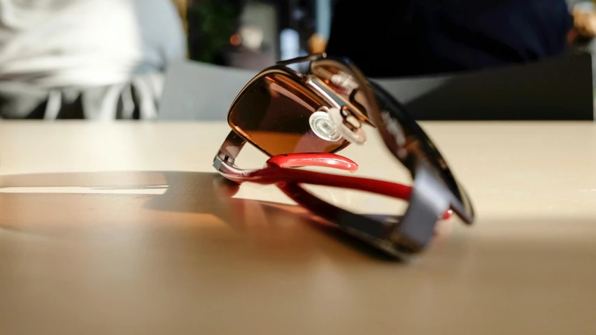 a pair of sun glasses laying on top of a table