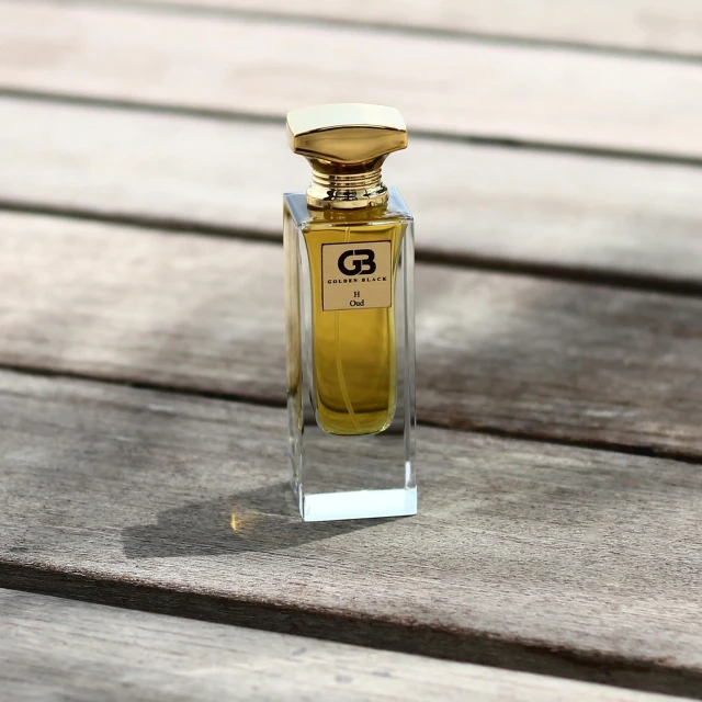 a bottle of perfume on top of a wooden table