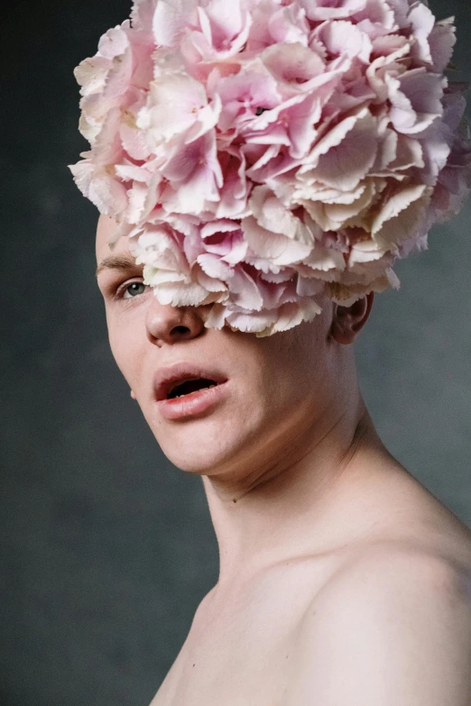 a  woman with a large pink flower on her head