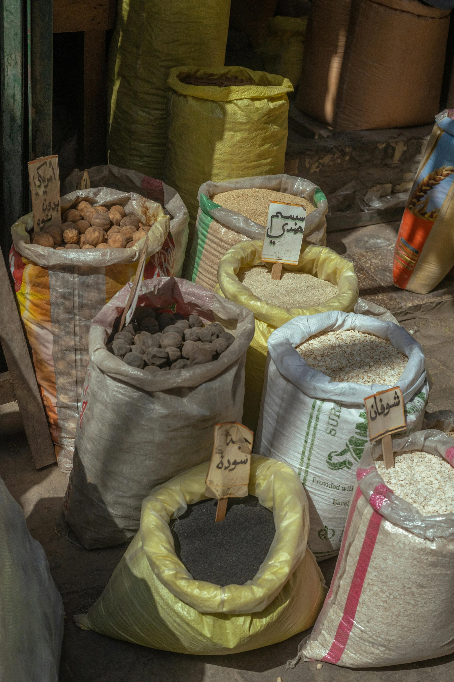 several bags and bags filled with peanuts on the ground