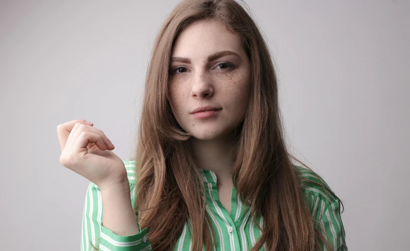 the woman is posing with a finger in her hand