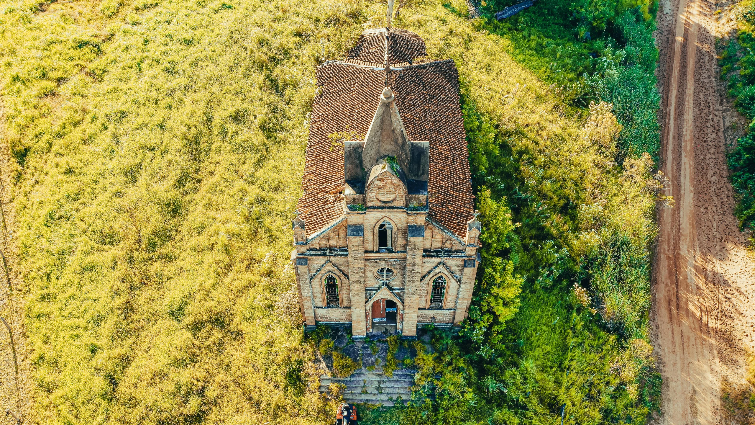 an old church surrounded by trees in a wooded area