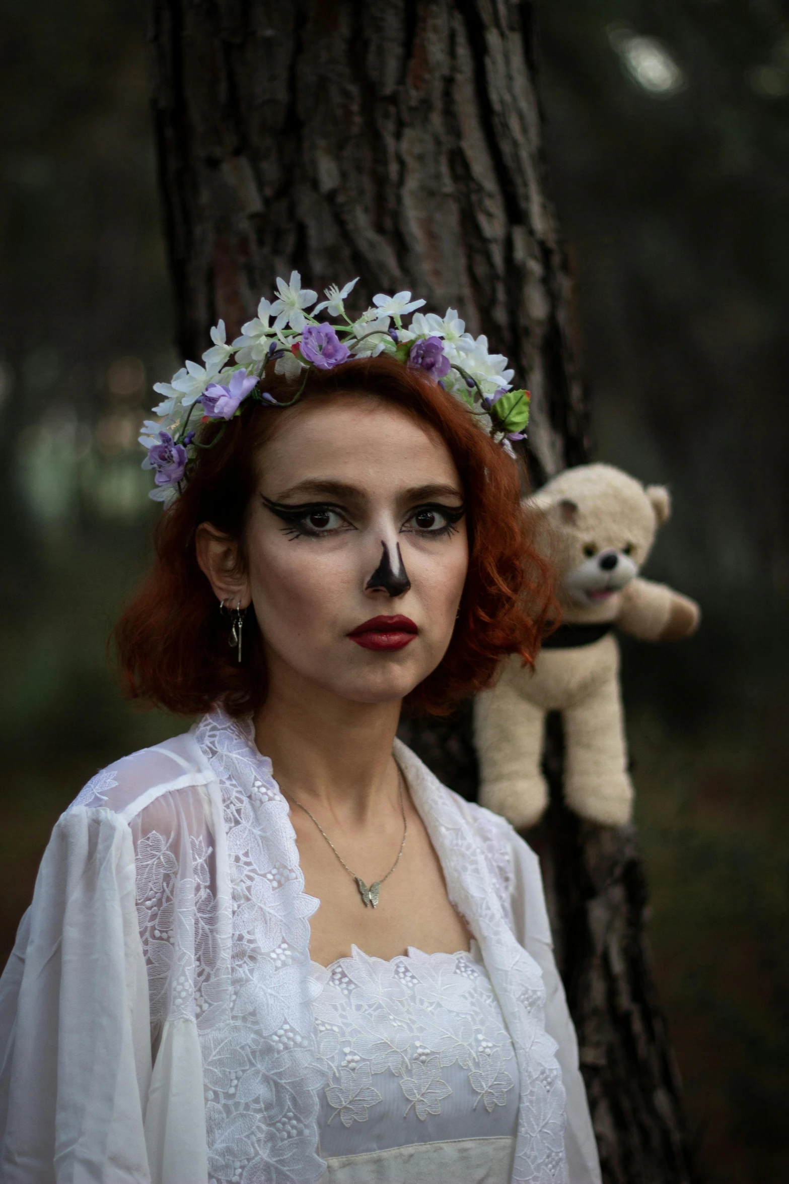 a woman is posing for a po near a tree