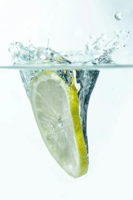 a slice of lemon in water that is being blown by the waves