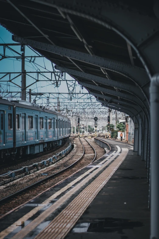 a train station with multiple trains on the tracks