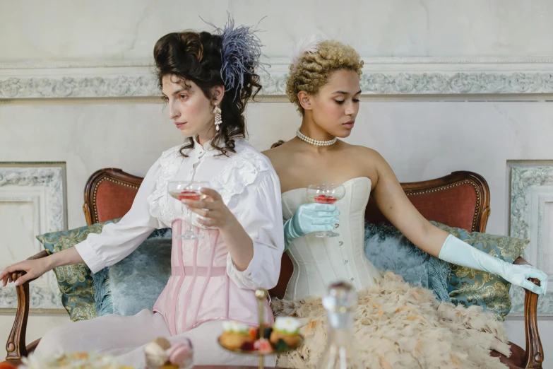 two beautiful women sitting down together for dinner