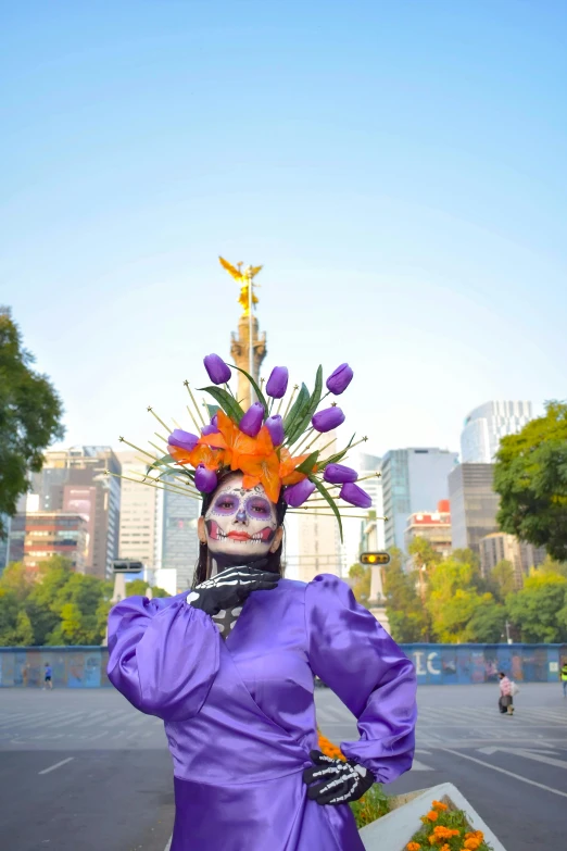 a woman wearing a colorful hat and purple dress