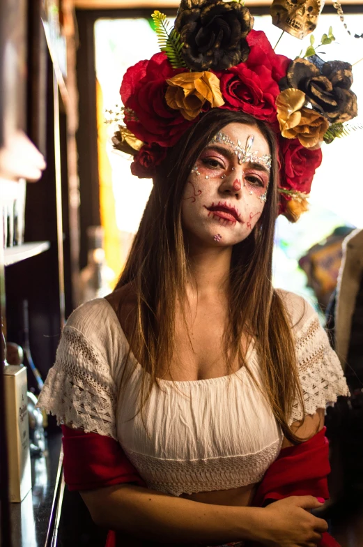 a person with face paint and wreath on