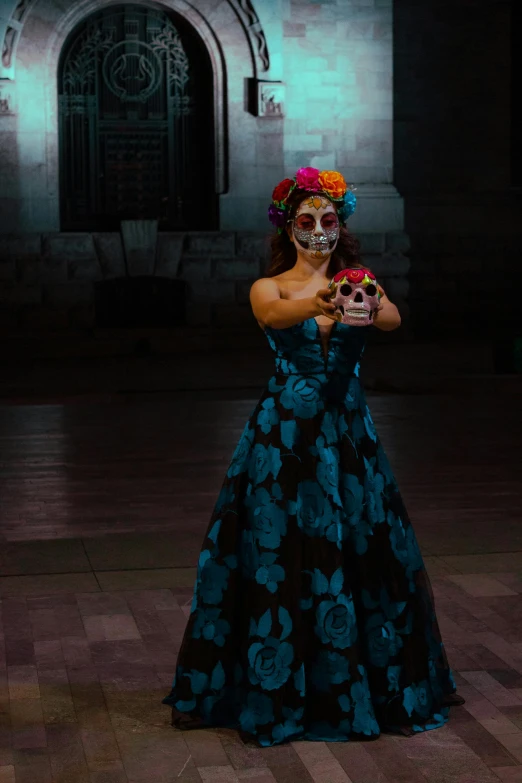 a woman is dressed in day of the dead gear, with a skull and flower crown on her head