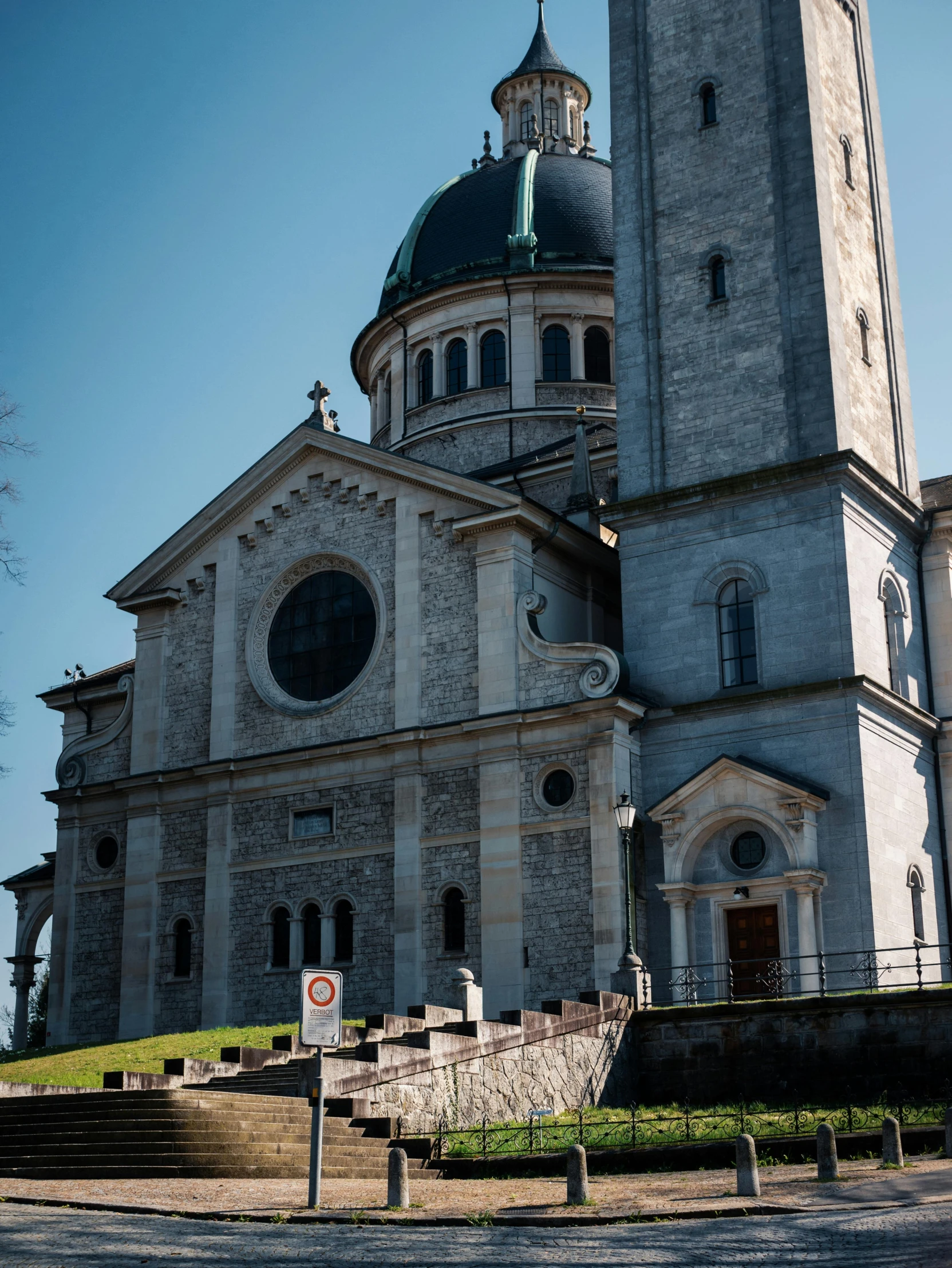 a large church with steeple and green dome