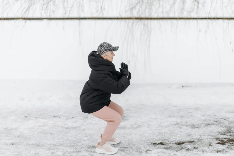 a girl is doing yoga in the snow