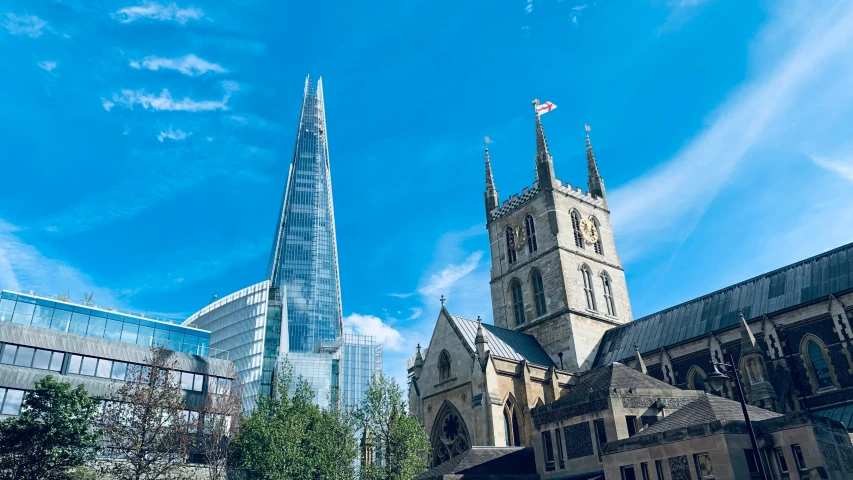 an architectural building with a flag flying over it in a city