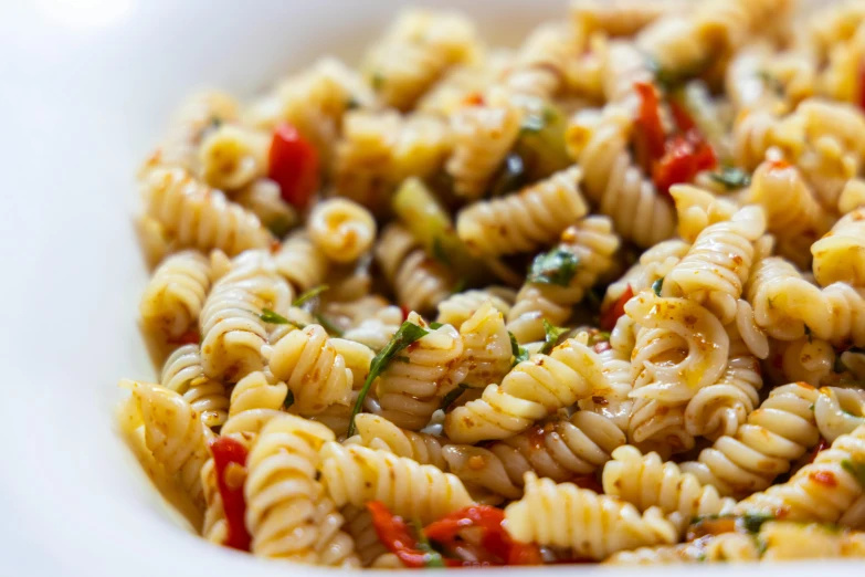 a bowl filled with pasta and cheese in sauce