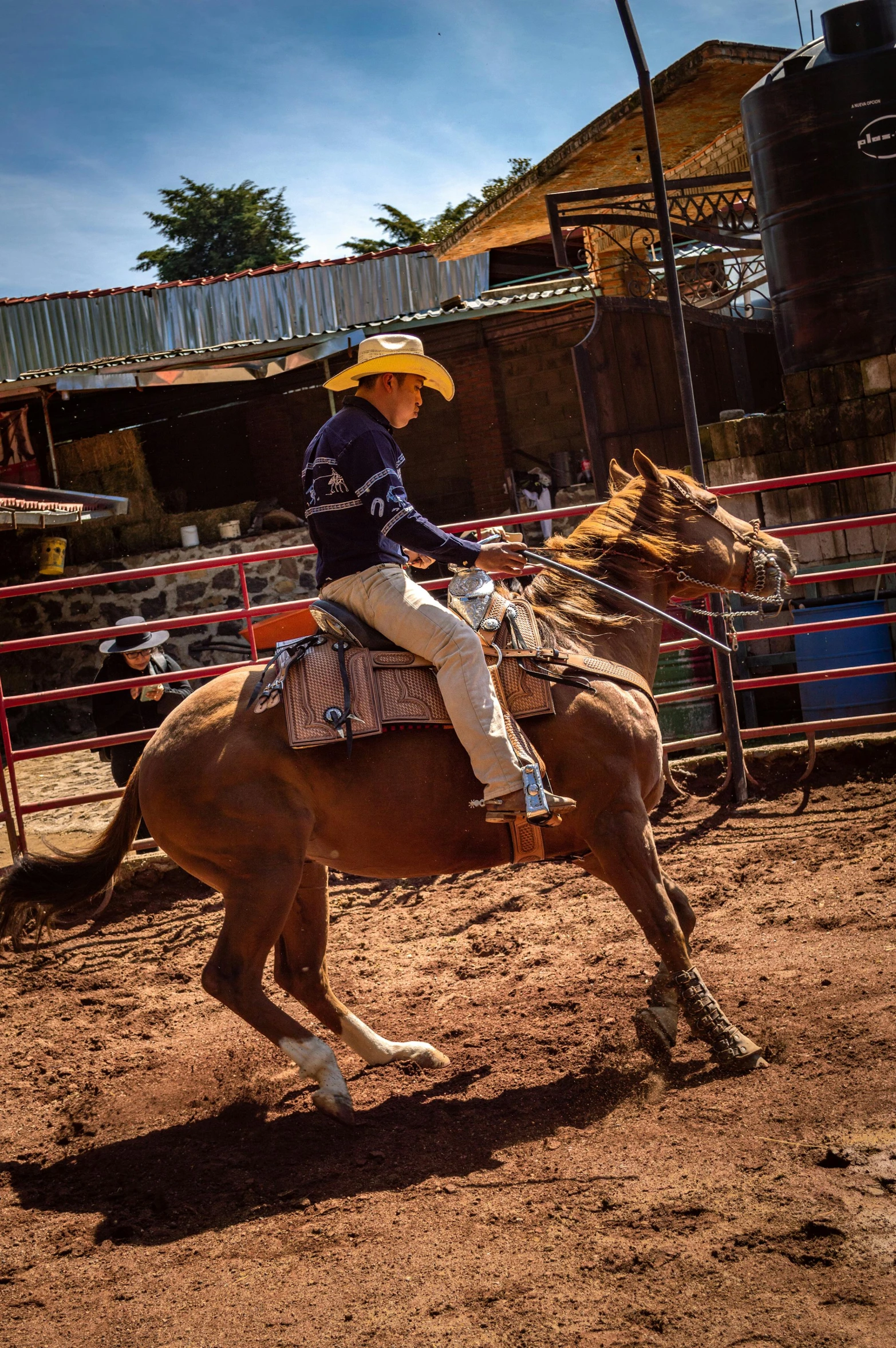 a man riding on the back of a horse in an open arena