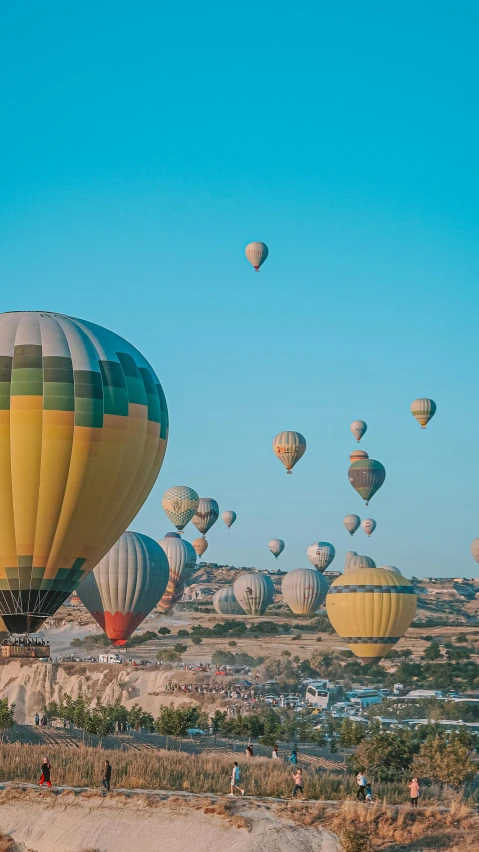 a large group of  air balloons being flown in the sky