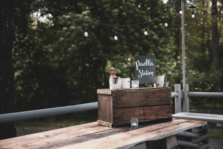 a table with liquor bottles on it and a sign