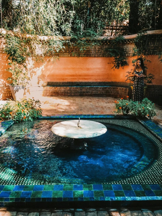 a bench is set up in a fountain with water flowing