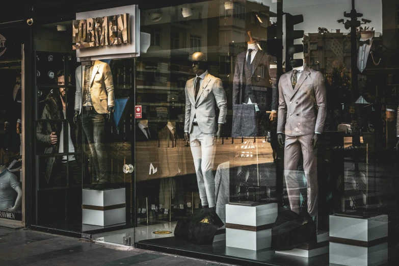 an image of a store window display with suits on display