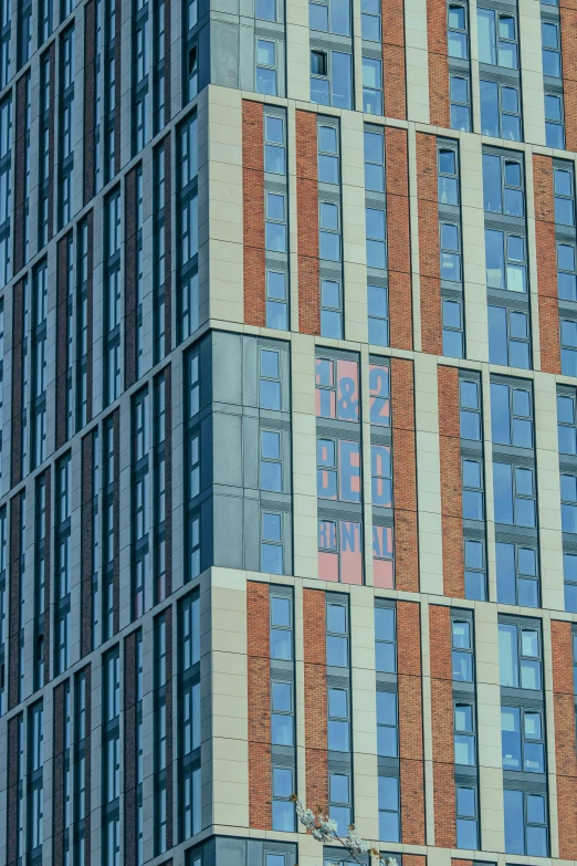 an orange and white building with windows in front of it