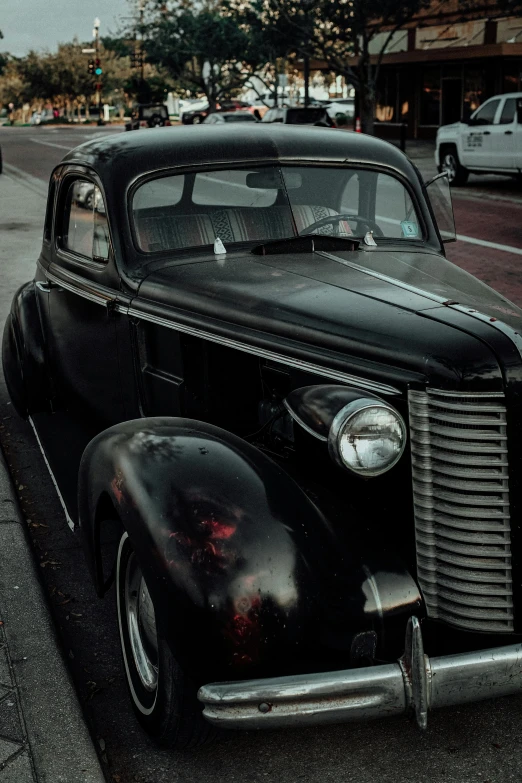 an antique black car parked at the curb