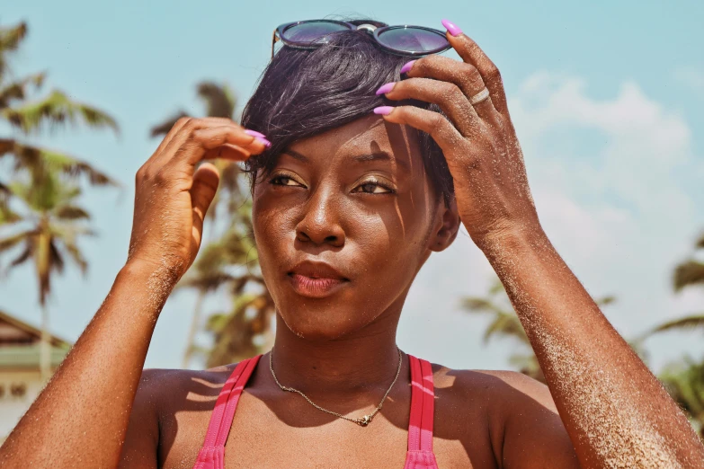 a woman with a bathing suit on and some sunglasses