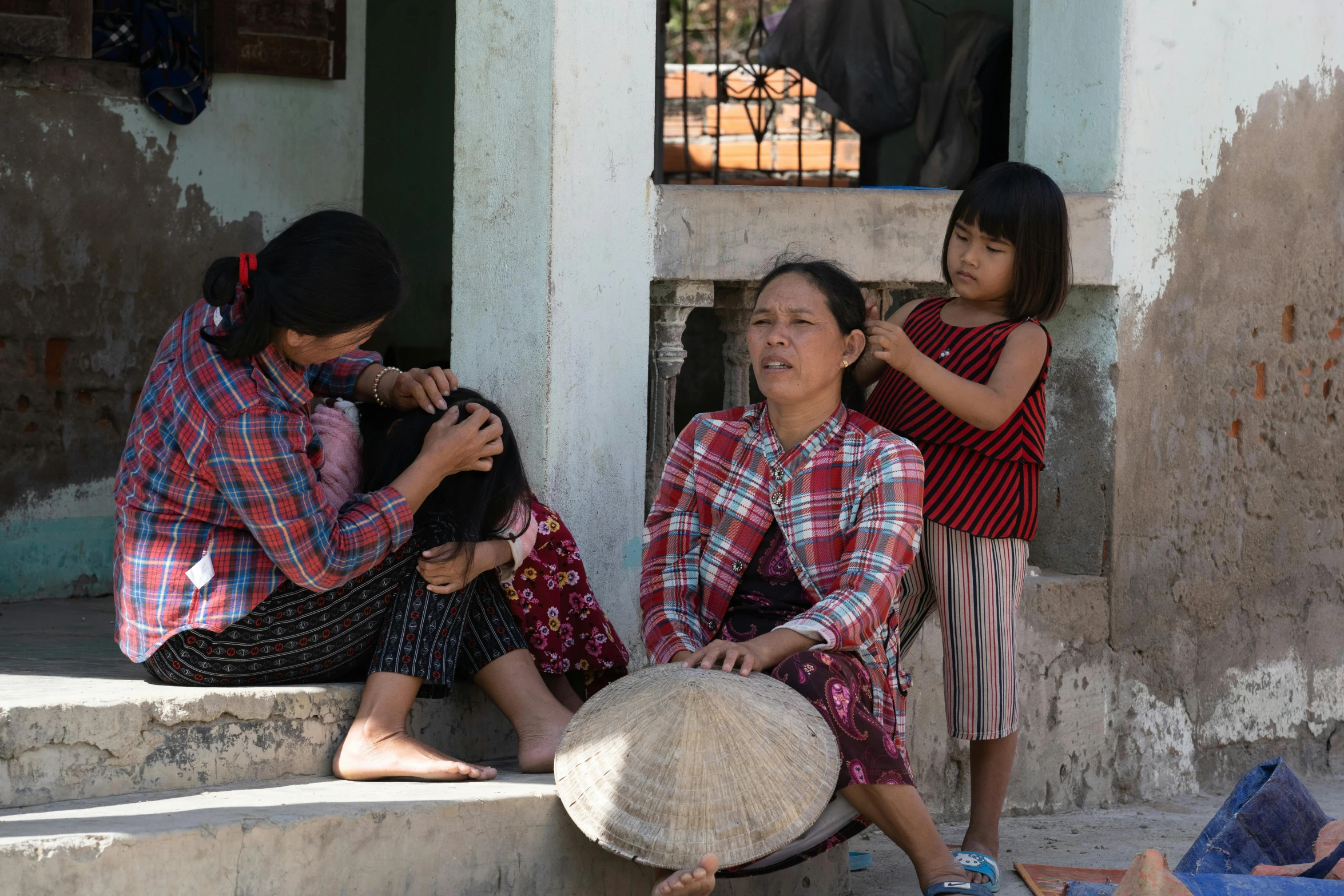 two women and a child on steps