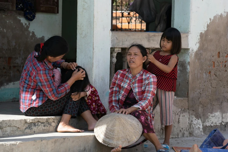 two women and a child on steps