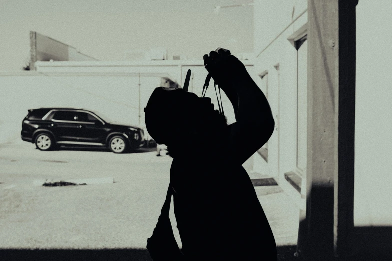 a woman holding up her camera in front of a window