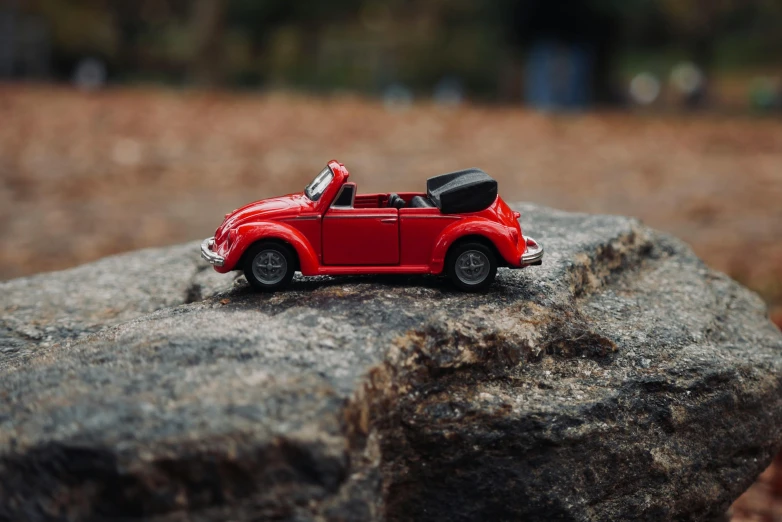 a toy car that is on some rocks