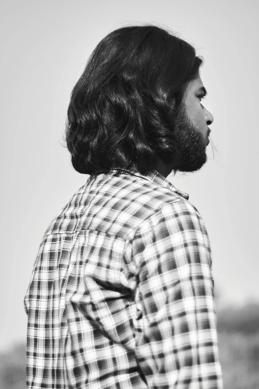 man with a beard standing in a field