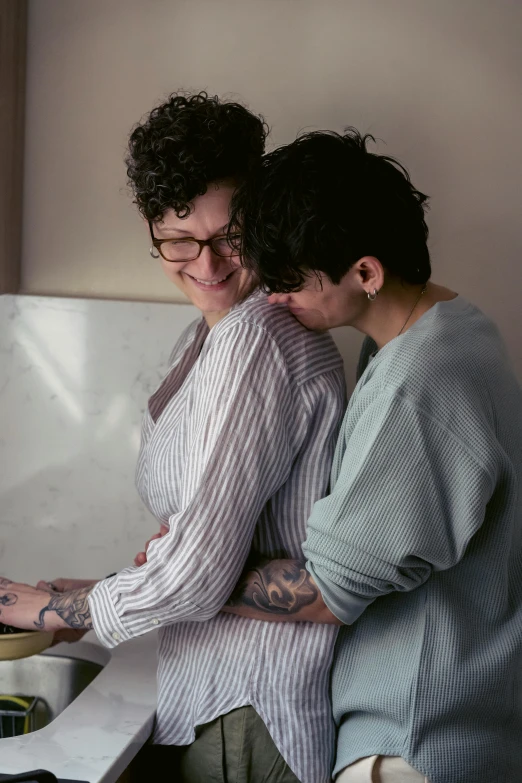 two women are cooking food together in the kitchen