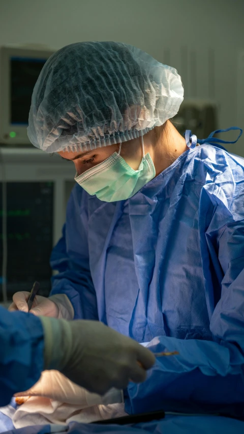 a man in blue surgical scrubs performing 
