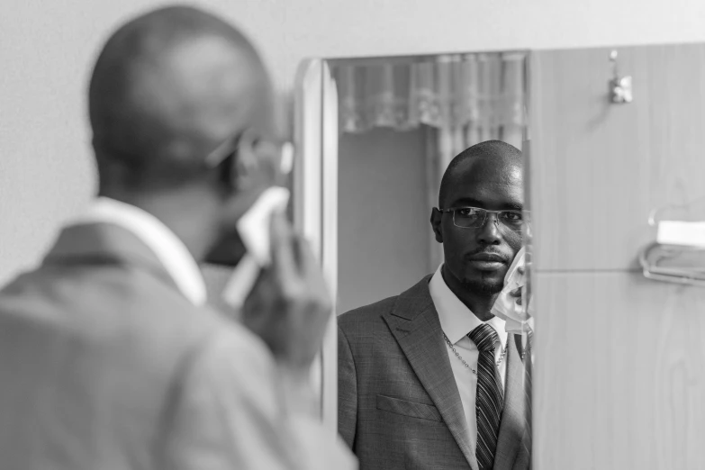 a man in a suit and tie with cell phone to his ear